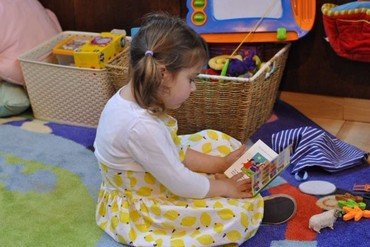 Photo of girl reading in our children’s corner